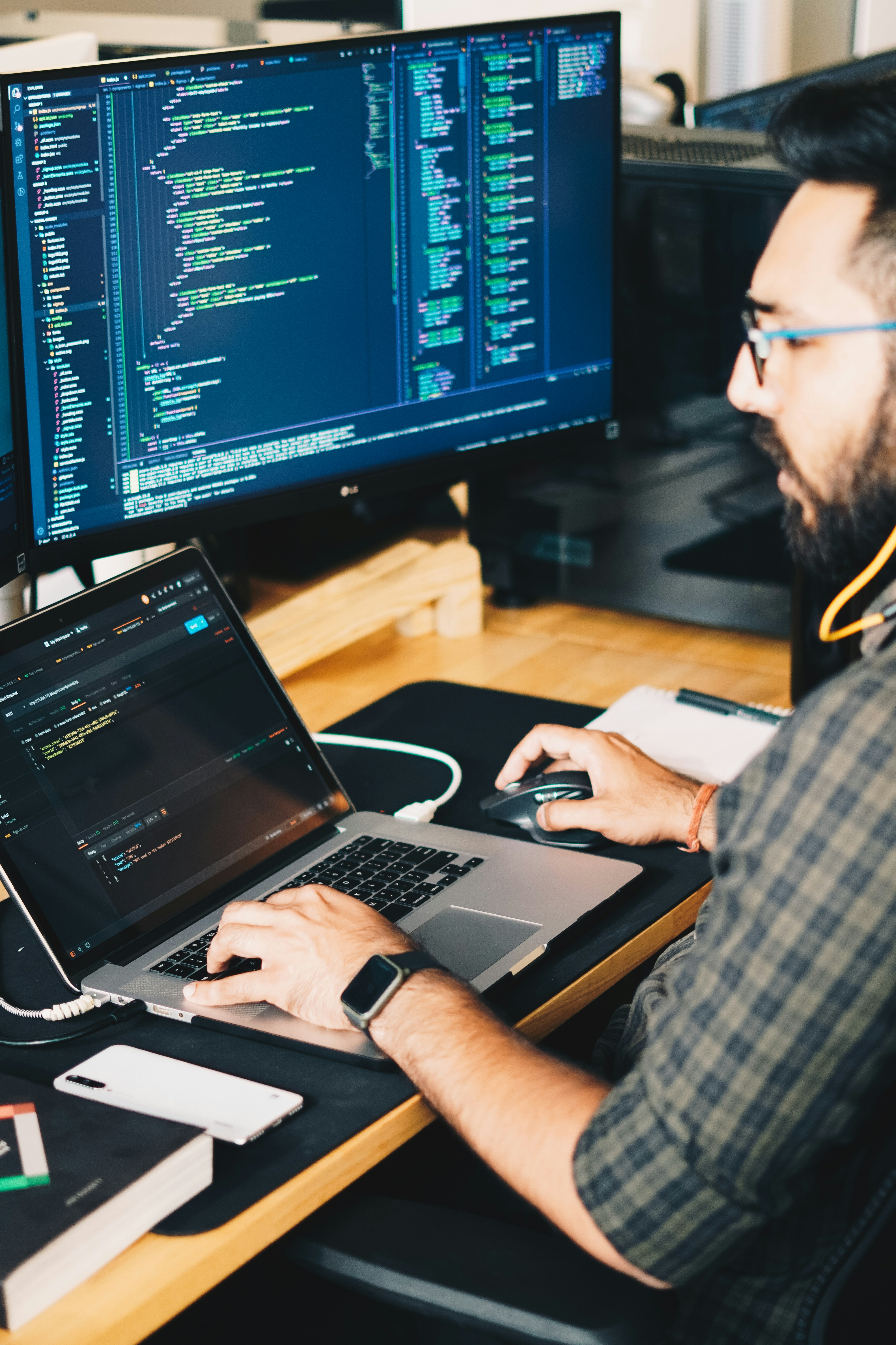 Developer working at a desk with dual monitors